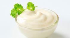 yogurt with parsley in a small glass bowl on a white background stock photo