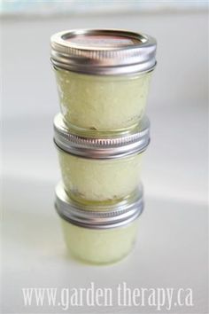 three jars filled with white powder sitting on top of a table