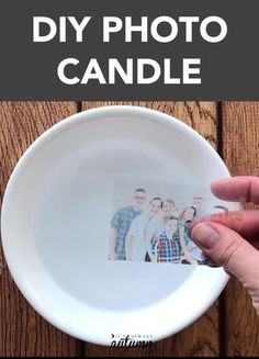 a person holding up a photo in a white bowl with the words diy photo candle on it