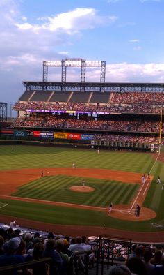 a baseball game in progress with the batter up to plate ready for the pitcher and umpire