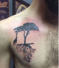 a man with a tree tattoo on his chest