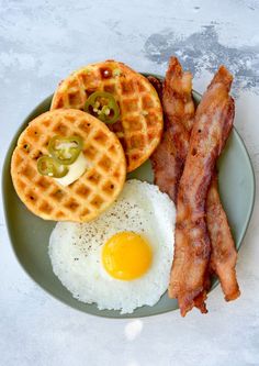 bacon, waffles and eggs on a plate