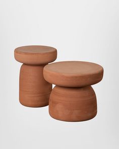 two clay stools sitting next to each other