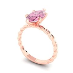 a pink diamond ring with twisted band and an oval shaped stone in the center, on a white background