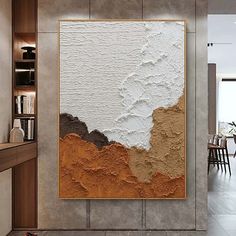 an abstract painting on the wall in a modern living room with wood and tile flooring