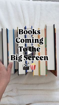 someone is reading a book with the title books coming to the big screen