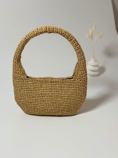 ✨I want you to meet our Mini Hobo Bag, one of the coolest pieces of this summer. A timeless piece that you will never regret owning and that you can combine with any outfit. Moreover, this bag is made of 100% environmentally friendly raffia yarns. 🌸 Since it is a timeless piece, you can choose it at any time of the day. Whether you're strolling in the park or having fun with your friends at the beach, this Mini Raffia Bag effortlessly completes your on-trend look. 🌸You can personalize this Raf Beige Crochet Straw Bag With Round Handle, Beige Crochet Bag With Round Handle And Handwoven Details, Beige Crochet Bag With Round Handle, Jute Crochet Shoulder Bag With Handles, Jute Crochet Shoulder Bag, Handwoven Straw Crochet Bag With Round Handle, Everyday Jute Crochet Handheld Bag, Handheld Jute Crochet Bag For Everyday Use, Everyday Handheld Jute Crochet Bag