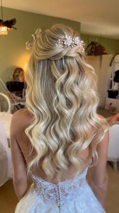 a woman with long blonde hair wearing a wedding dress