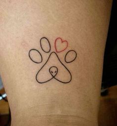 a dog's paw and heart tattoo on the ankle