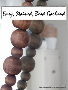 a wooden bead hanging from the side of a mirror with text overlay that says easy, stained, bad garland