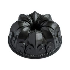 a black bundt cake on a white background