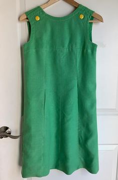 Vintage, mod green shift dress with yellow buttons, sleeveless, size XS, possibly S (see measurements in photos) comes with replacement button I LOVE this dress. It is quintessential Mod 60s style, in my mind. But it needs a little love and care. Both pockets have holes (one pictured), and the zipper on the back of the dress needs replacing (also pictured). Both should be fairly easy, but I have reduced the price to reflect the wear and tear. Mod Sleeveless Dresses With Buttons, Green Buttoned Mini Dress For Work, Vintage Green Dress For Work, Retro Green Dress For Work, Classic Green Dress With Buttons, Green Mod Knee-length Dress, Green Knee-length Mod Dress, Retro Green Dress With Buttons, Mod Green A-line Dress