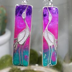 "One of a kind clay (blue, pink, purple and green blend) and resin (creates a glass like finish) standing crane earrings. Sterling silver charms are approximately 44x12mm with marbled clay which looks like stained glass. Hung on sterling silver ear wires.  Approximate length 2.75\".  Photos taken in studio light.  Free U.S. shipping on orders over $35. International shipping available. Same item as shown, contact me for free sizing adjustments. Shipped in a sealed and protected plastic bag. Free customer consultation offered to create a client profile I keep on hand with measurements and preferences for future orders. Thanks so much!  Smiles Jill" Artistic Purple Earrings For Gift, Artsy Purple Drop Earrings, Artistic Purple Jewelry With Matching Earrings, Unique Hand Painted Purple Earrings, Artistic Nickel-free Purple Jewelry, Artistic Purple Nickel-free Jewelry, Artistic Hand Painted Purple Jewelry, Artsy Purple Jewelry For Gifts, Hand Painted Purple Earrings As Gift