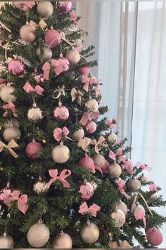 a decorated christmas tree with pink and white ornaments