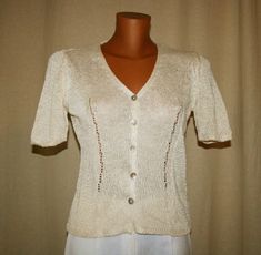 ❤️Beautiful Vintage 80s, Blouse with short sleeves, v neck,  buttons row, in beige color. A timeless gift! 55% viscose 45 % linen -Made in Italy Size : 40/ 42 Italian Dimensions: Shoulder to shoulder 34 cm. Breast 44 cm. 53 cm long Hand wash, cold water. Good vintage condition, from Italy ❤️If you love real vintage, take a look at my sister and friend shop !! Enjoy!! www.etsy.com/it/shop/TheReaItalianVintage www.etsy.com/it/shop/DreamInTheDrawer www.etsy.com/it/shop/Reinayestrellas Customer sati Elegant Vintage Summer Tops, Vintage Fashion Short Sleeve Blouse For Summer, Vintage Fashion Short Sleeve Tops, Summer Vintage Style Short Sleeve Blouse, Cream Short Sleeve Top For Formal Occasions, Formal Cream Short Sleeve Top, Vintage Cream Blouse For Summer, Vintage Beige Blouse With Short Sleeves, Vintage V-neck Blouse For Formal Occasions