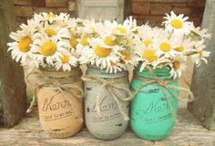 four different pictures with flowers in mason jars and chalkboard signs on the sidelines