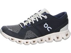 a women's running shoe with white and blue laces on the outstrap