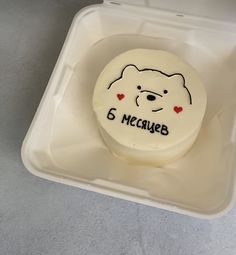 a cake in a plastic container with writing on it