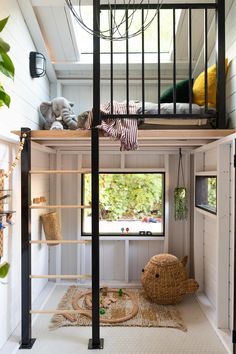 there is a loft bed in the middle of this room with ladders on it