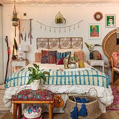 a bedroom decorated in bohemian style with wicker furniture and plants on the wall above the bed