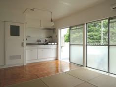 an empty kitchen with sliding glass doors leading to the outside