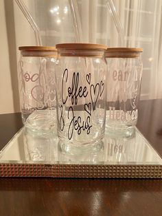 three glass cups with the words coffee jesus written on them are sitting on a tray