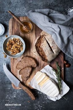 bread, nuts and butter on a cutting board