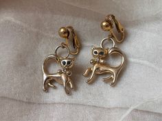 "These cute midcentury earrings feature gold plated cats with baby blue rhinestone colored eyes and little bows around their necks, hanging from clip on settings. It measures 1.5\" x .75\" and has minimal wear from age, primary some slight plating loss in the areas around the hoops." Rhinestone Eyes, Something Old, Blue Rhinestones, Kitty Cat, Formal Wedding, Clip On, Wedding Bride, Vintage Gold, Clip On Earrings