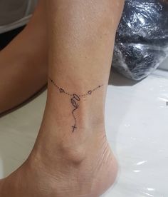 a woman's foot with a small tattoo on the ankle that reads, love is in the air