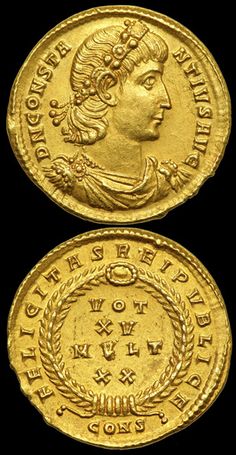 an ancient gold coin with the image of a woman's head on it, and two