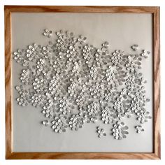 an art work with buttons in a wooden frame