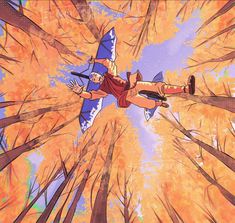 an animated image of a man flying through the air in front of trees with orange leaves