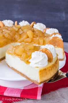 a piece of cheesecake with whipped cream and pineapple topping on a white plate