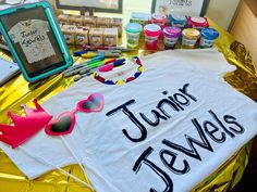 a t - shirt that says junior jewels sits on a table with other craft supplies