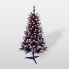 a small christmas tree with white lights and snow on the branches is shown in front of a gray background