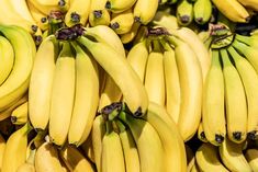 several bunches of bananas are stacked on top of each other