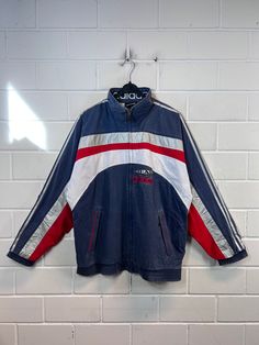 Vintage Adidas Size M Shelljacket Sportsjacket Windbreaker old School Jacket 80s 90s Vintage sports jacket from Adidas in size M, one side pocket with zipper on the right and left Color: dark blue red white silver Defects: the cuffs are no longer elastic materials outside polyamide / nylon polyester inside Dimensions: Length 73cm Width 63 cm Arm length from collar 79 cm If you still have any questions, just write to me :) Retro Sport Coat With Pockets For Streetwear, Vintage Hooded Track Jacket, Retro Hooded Track Jacket With Pockets, 90s Style Long Sleeve Track Jacket With Pockets, Retro Cotton Track Jacket For Outdoor, 90s Sports Outerwear With Pockets, 90s Style Sports Outerwear With Pockets, 90s Style Track Jacket With Pockets For Streetwear, 90s Style Track Jacket With Pockets For Sports