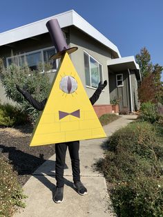 a person wearing a costume made to look like a yellow triangle with a hat on it's head