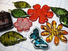 many different types of glass flowers on a cutting board with scissors and paper towels in the background