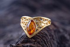 Art Gemelli present's lovely ring made of natural Baltic amber. It has been lovely set in sterling silver and covered by 14 CT gold layer. Cognac type of amber. Celtic heritage inspired design. Perfect for everyday use. Ideal gift.    Perfectly polished cognac Baltic amber set in 925 sterling silver setting and covered by 14 CT gold layer.    This ring comes with LIFETIME CRAFTWORK WARRANTY for your peace of mind. Gift wrap is also provided.    We source our amber from Baltic coast often looking Amber Diamond Ring, Amber And Gold Jewelry, Amber Ring Engagement, Amber Engagement Ring, Elegant Gold Jewelry, Earthy Rings, Amber Rings, Freeform Ring, Fashion Jewelry Rings