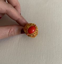 Vintage gold tone coral colored cabochon center adjustable ring in great vintage condition. Ornate Gold Cabochon Rings, Vintage Cabochon Ruby Ring, Vintage Ruby Cabochon Ring, Vintage Brass Cabochon Rings, Vintage Orange Cabochon Rings, Bunny Necklace, Rabbit Pendant, Coral Ring, Gold Ring Designs