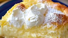 a piece of pie with whipped cream on top is sitting on a blue and white plate