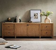 a room with a bed, dresser and pictures on the wall