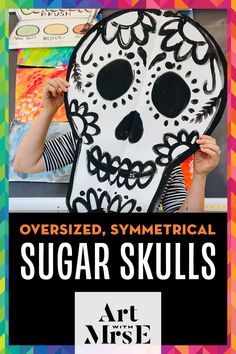 a person holding up a paper mask with the words over sized, symmetrical sugar skulls on it