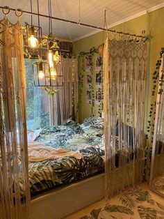 a bed room with a neatly made bed and hanging curtains