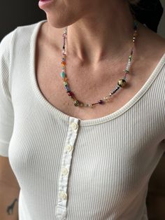 Discover a unique fusion of elements in our Unique Boho Beaded Necklace, a piece that artfully marries the ethereal sparkle of crystals, the soothing energies of rose quartz, and the timeless elegance of pearls. This 22-inch beaded necklace is a testament to creativity and craftsmanship, expertly handcrafted to captivate hearts. Featuring an array of captivating gemstones and glass beads, this necklace is more than an accessory; it's a work of art that invites you to explore its intricate details. Sparkling crystals add a touch of enchantment, illuminating your aura and creating a mesmerizing visual effect. Jade beads, both in its vibrant green and calming purple forms, infuses the necklace with its unique energies. Green jade promotes harmony and balance, while purple jade enhances spirit Fusion Style Colorful Beads Jewelry For Festival, Bohemian Gemstone Beads For Wedding, Fusion Style Beaded Necklaces For Gifts, Spiritual Beaded Necklace With Colorful Beads For Wedding, Elegant Multicolor Beaded Necklaces With Spacer Beads, Artisan Multicolor Necklaces For Wedding, Artisan Multicolor Necklace For Wedding, Wedding Multicolor Necklaces With Faceted Beads, Bohemian Faceted Beads Necklaces For Weddings