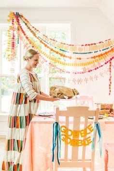 a woman standing in front of a table