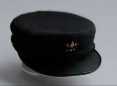 a black hat is sitting on a clear base