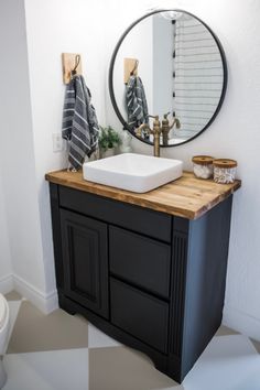 a bathroom with a sink, mirror and towel rack on the wall above it's counter