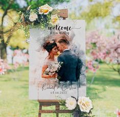 a welcome sign for a newly married couple in front of some pink and white flowers